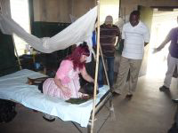 Linnie prays for a young TB sufferer